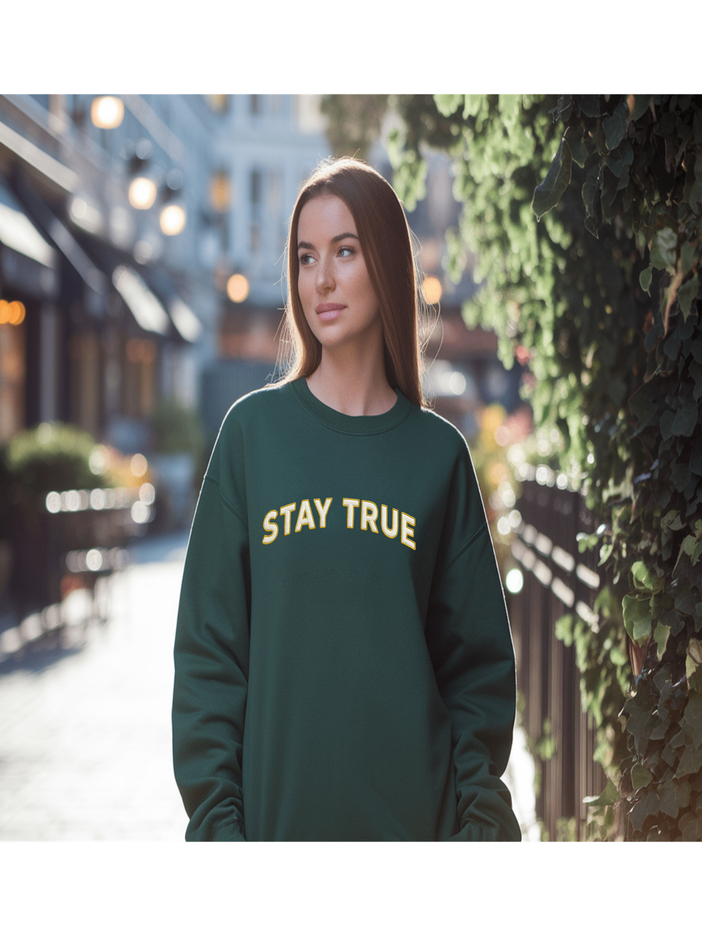 Woman wearing Embroidered Stay True Sweatshirt in forest green, street style.