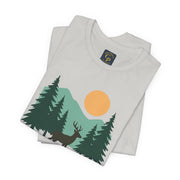 Forest Dreamer T-Shirt in light blue with forest and sun design, laid flat on surface