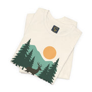 Flat lay of Forest Dreamer T-Shirt with woodland scene and golden sun