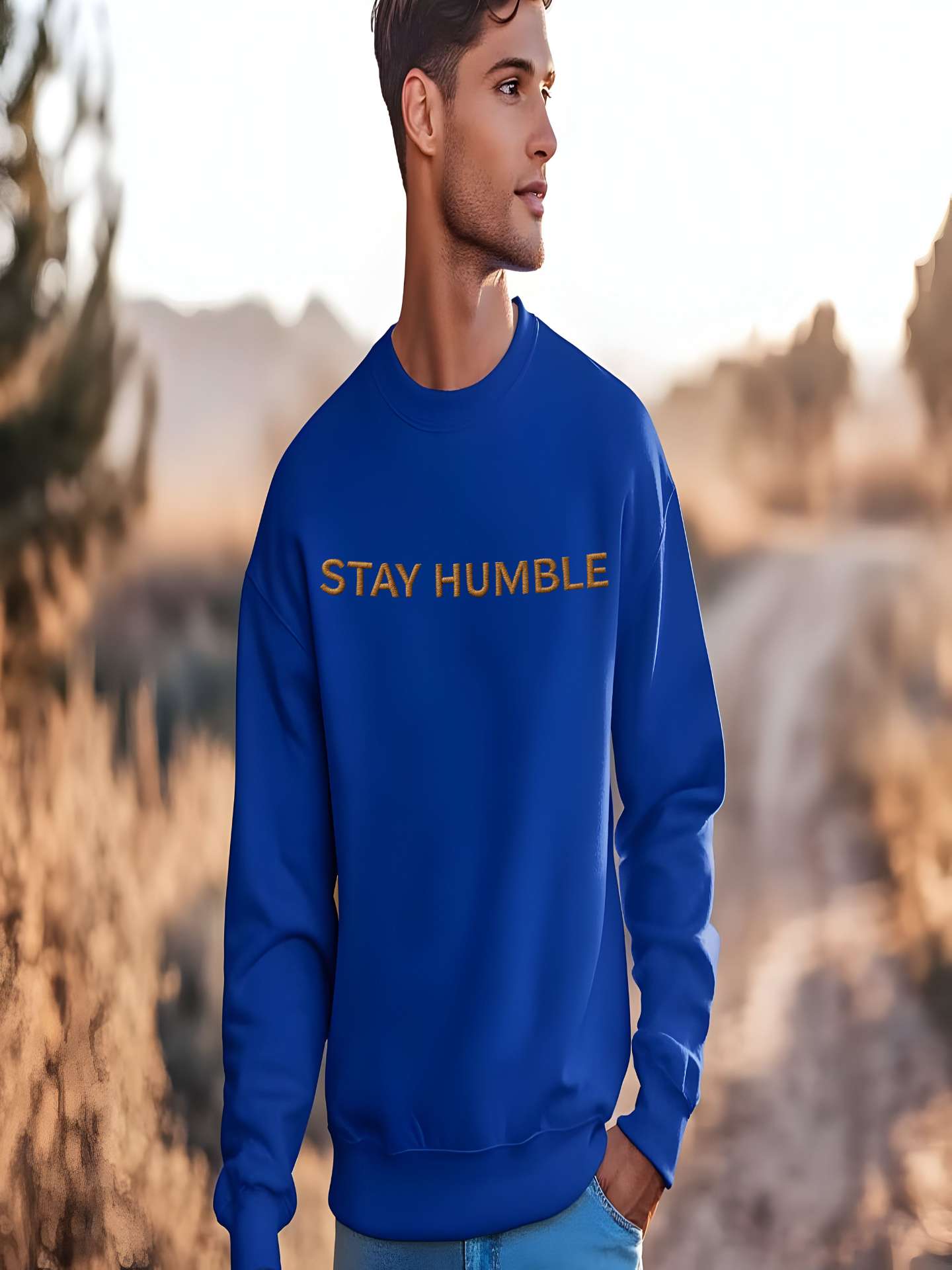 Man wearing blue Embroidered Humble Sweatshirt outdoors