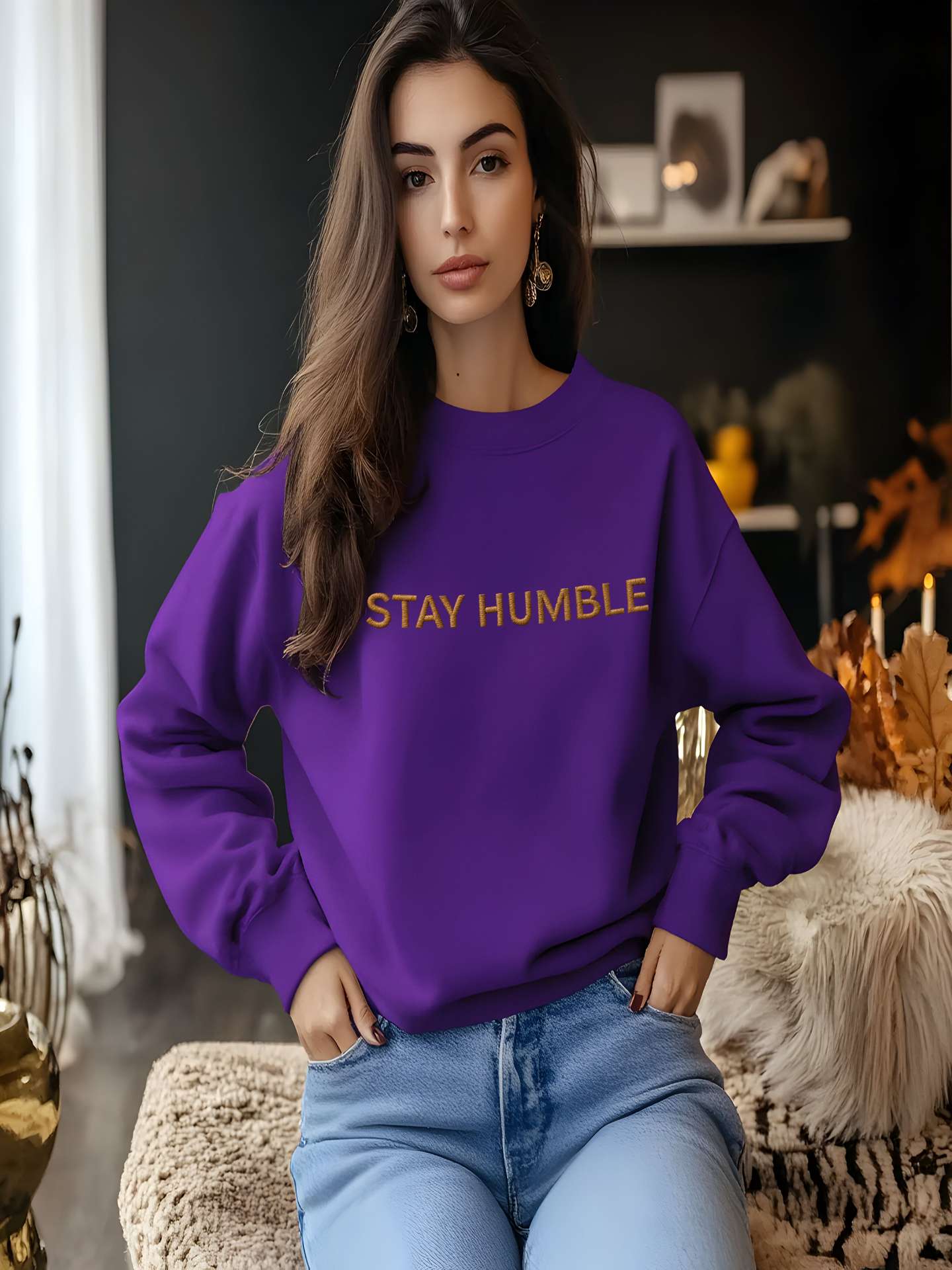 Woman sitting indoors in purple Embroidered Humble Sweatshirt
