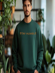 Man wearing green Embroidered Humble Sweatshirtwith kindness design