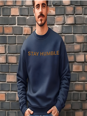 Man modeling dark gray Embroidered Humble Sweatshirt against brick wall