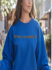 Woman wearing blue Embroidered Humble Sweatshirt while walking outdoors