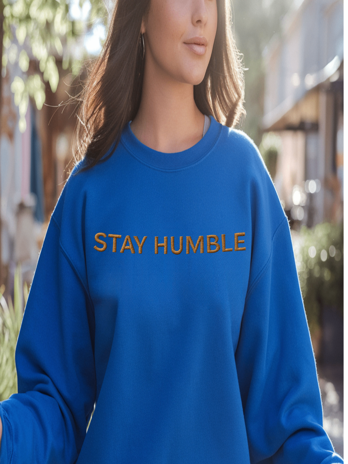 Woman wearing blue Embroidered Humble Sweatshirt while walking outdoors