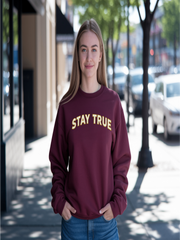 Woman in maroon Embroidered Stay True Sweatshirt posing outdoors.