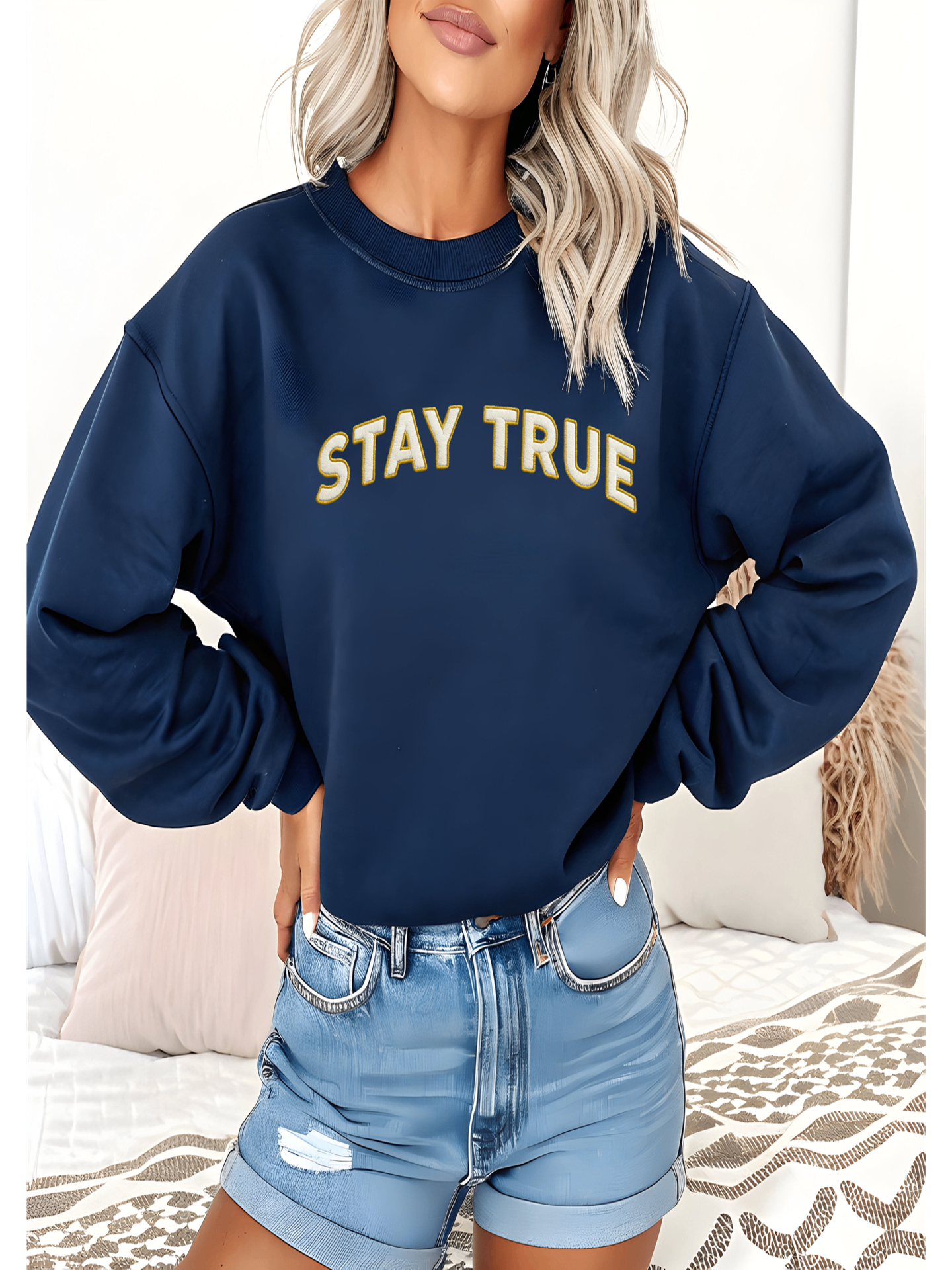 Woman wearing Embroidered Stay True Sweatshirt in navy blue, casual style.