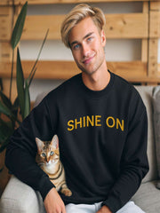 Young man sitting wearing Embroidered Shine On Sweatshirt in black