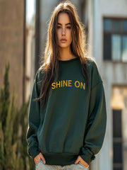 Woman modeling Embroidered Shine On Sweatshirt in forest green, daylight