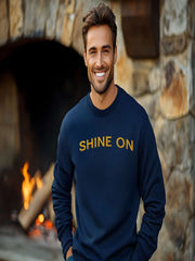 Man by fireplace in navy Embroidered Shine On Sweatshirt