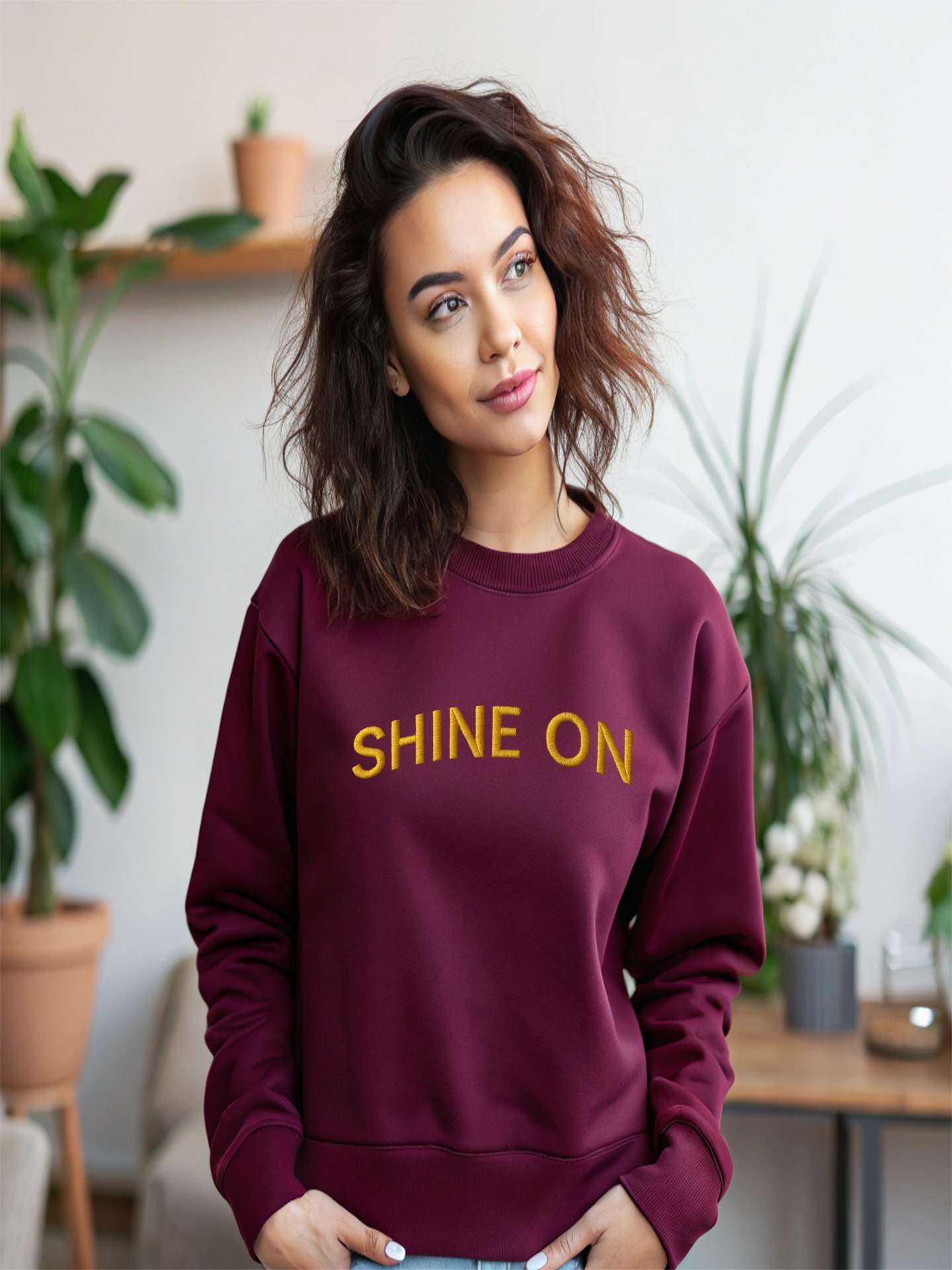 Woman wearing maroon Embroidered Shine On Sweatshirt indoors