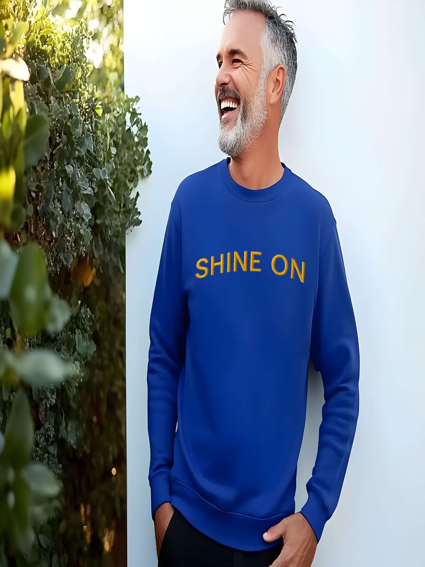 Man smiling in royal blue Embroidered Shine On Sweatshirt