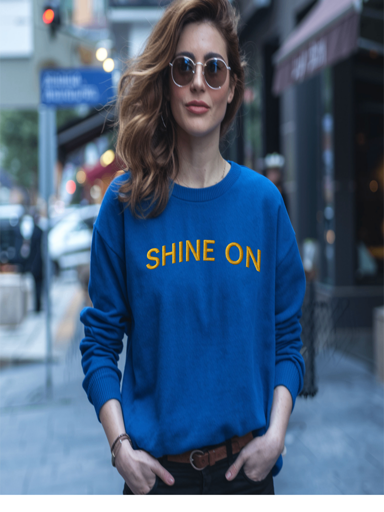 Woman in blue Embroidered Shine On Sweatshirt walking outdoors