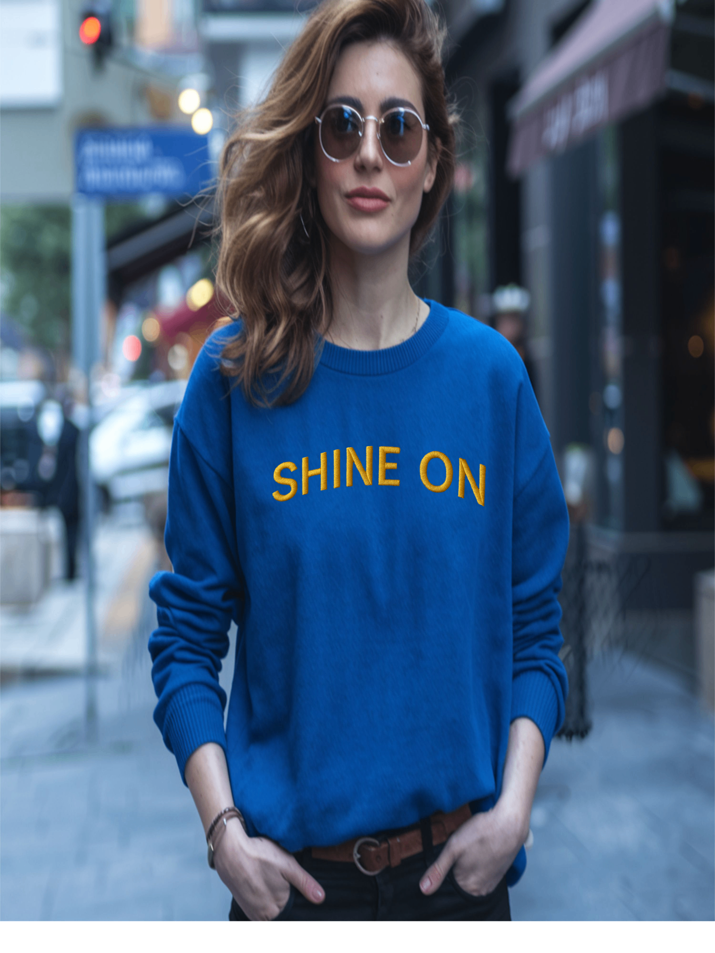 Woman in blue Embroidered Shine On Sweatshirt walking outdoors