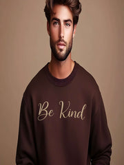 Man wearing brown Embroidered Kindness Sweatshirt studio pose