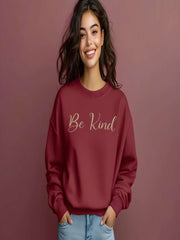 Woman smiling in maroon Embroidered Kindness Sweatshirt studio photo
