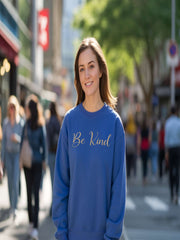 Woman outdoors wearing blue Embroidered Kindness Sweatshirt in urban setting.