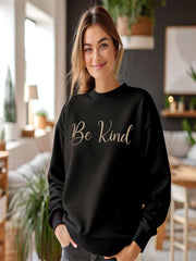 Woman smiling indoors in black Embroidered Kindness Sweatshirt