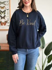 Woman modeling navy Embroidered Kindness Sweatshirt indoor photo
