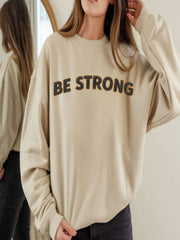 Embroidered Motivational Sweatshirt - Be Strong, Stay Grounded worn by model, showcasing the motivational message.