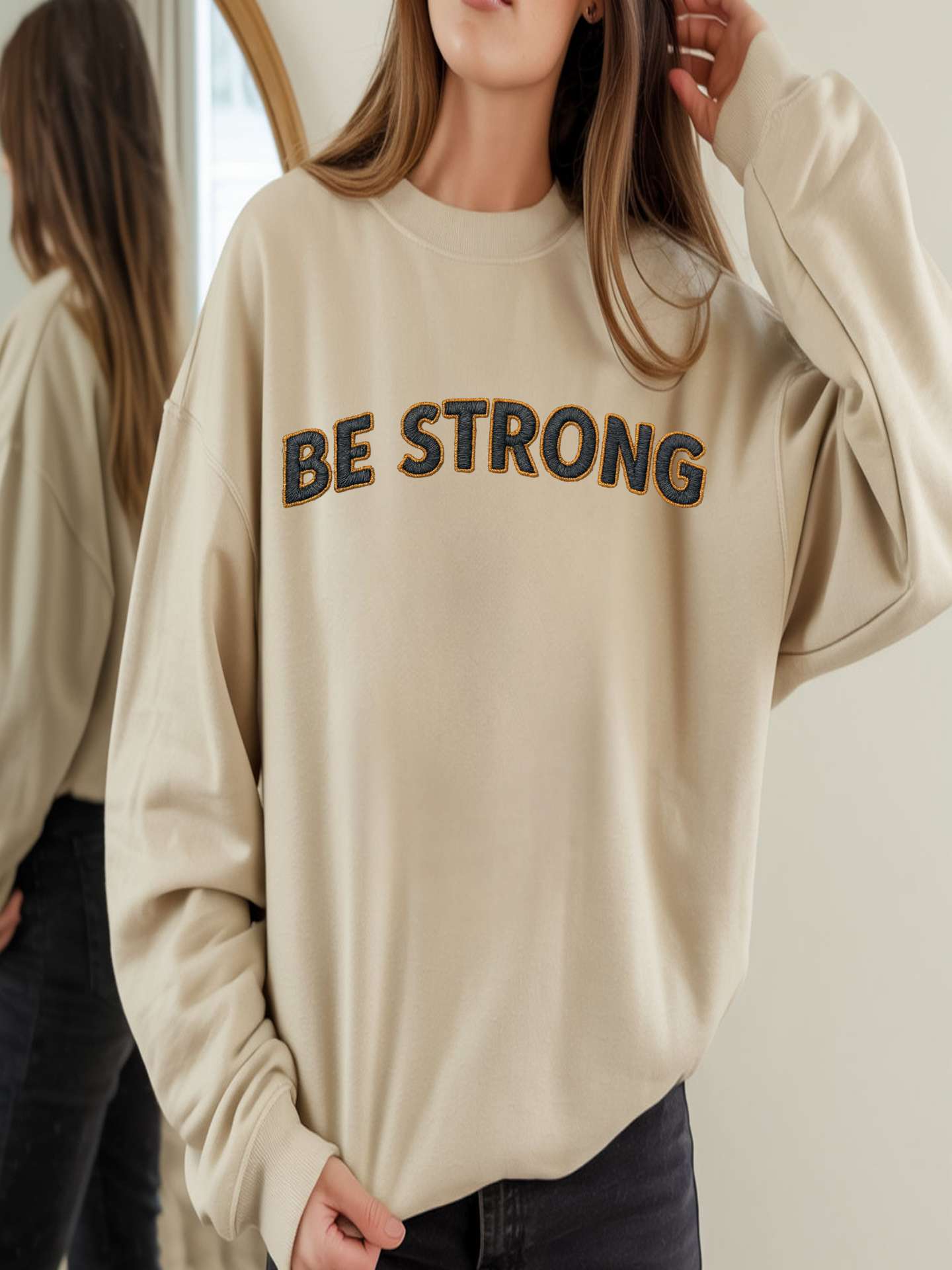 Embroidered Motivational Sweatshirt - Be Strong, Stay Grounded worn by model, showcasing the motivational message.