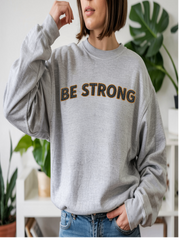 Embroidered Motivational Sweatshirt featuring the phrase 'BE STRONG' on a gray background, perfect for casual wear.