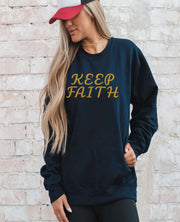 Man with cap wearing Embroidered Keep Faith Sweatshirt in black
