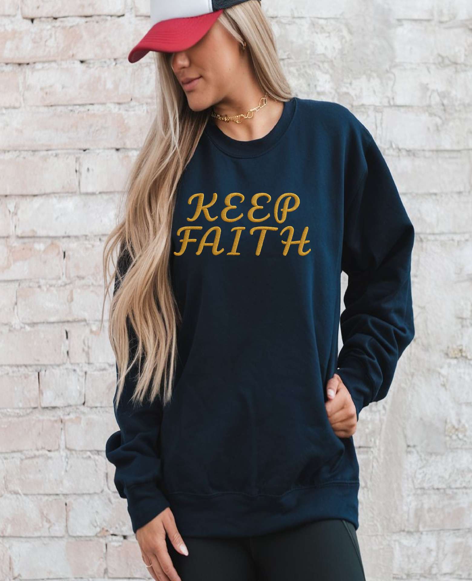 Man with cap wearing Embroidered Keep Faith Sweatshirt in black