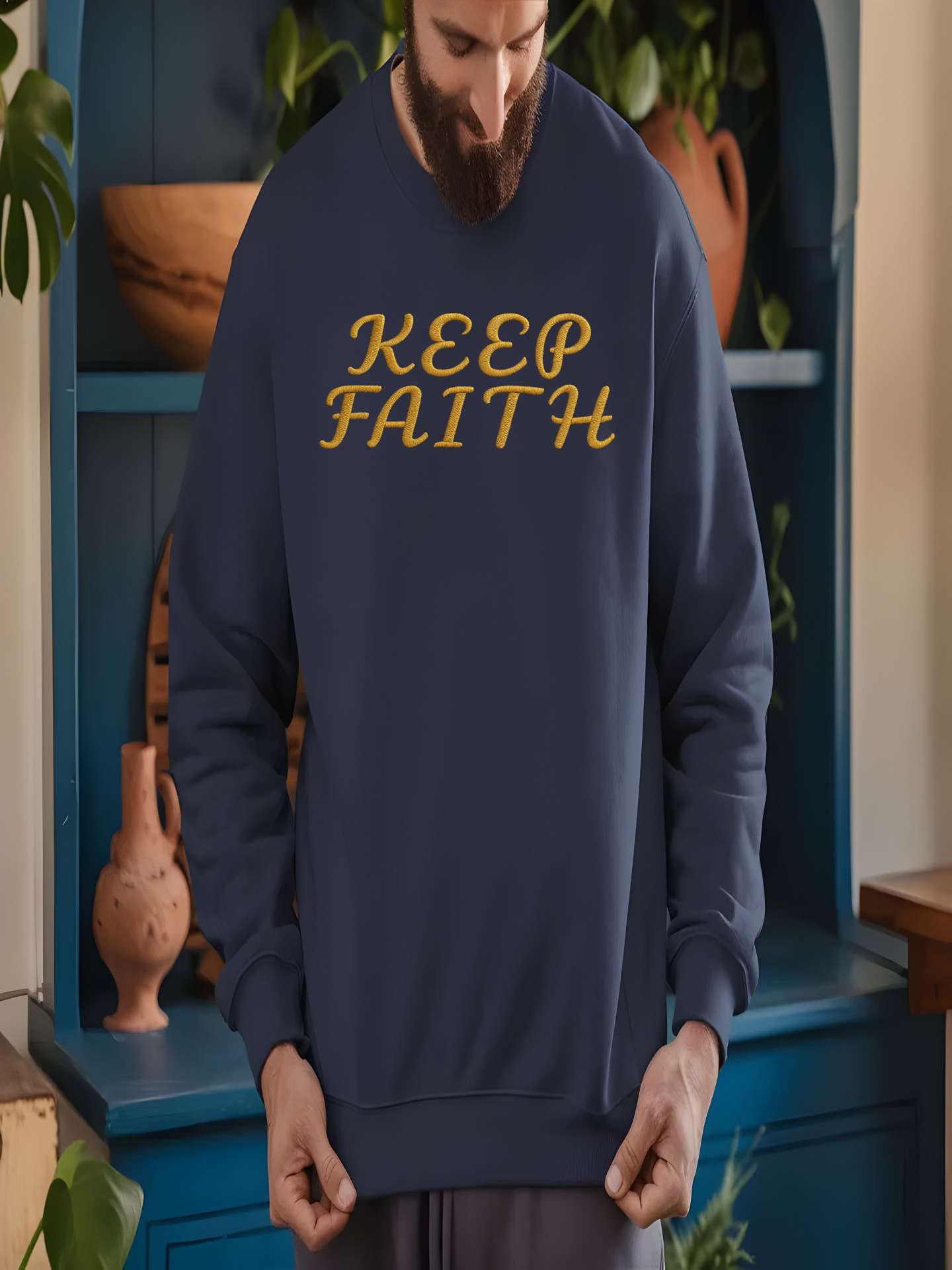 Man indoors wearing Embroidered Keep Faith Sweatshirt in navy