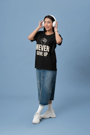 Woman wearing a motivational t-shirt that says 'NEVER GIVE UP' with a fist graphic, showcasing resilience.