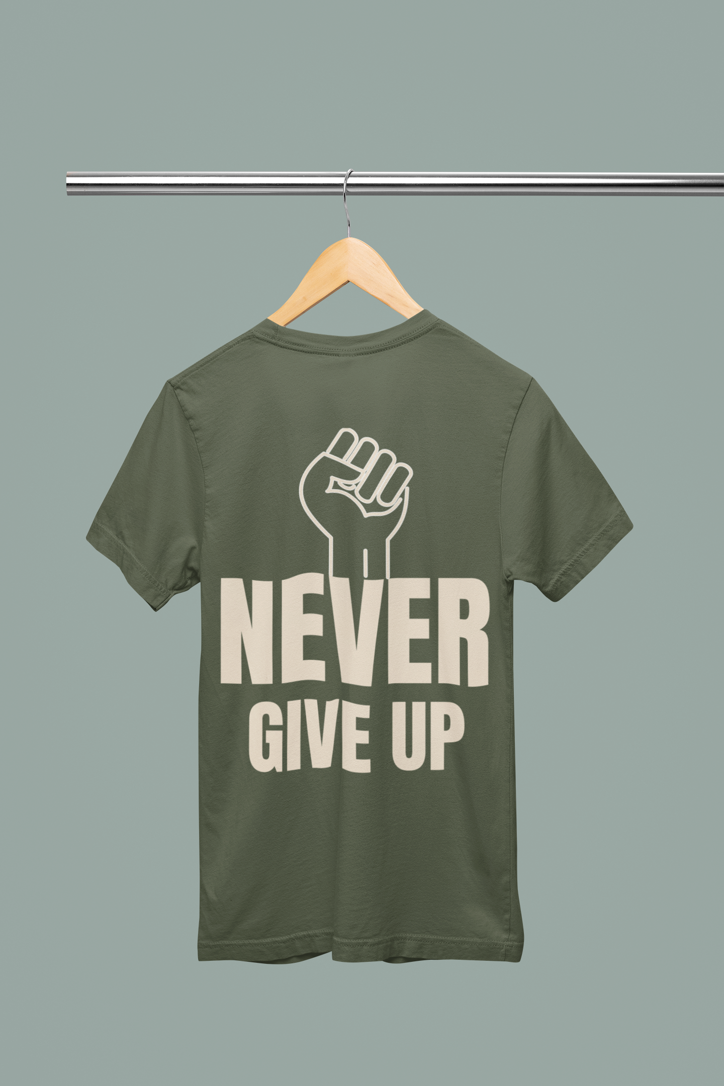 Motivational t-shirt with a bold 'NEVER GIVE UP' slogan and raised fist graphic on green fabric, perfect for inspiring resilience.