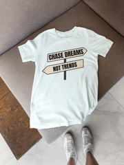 Chase Dreams T-Shirt folded on beige blanket with neutral lighting
