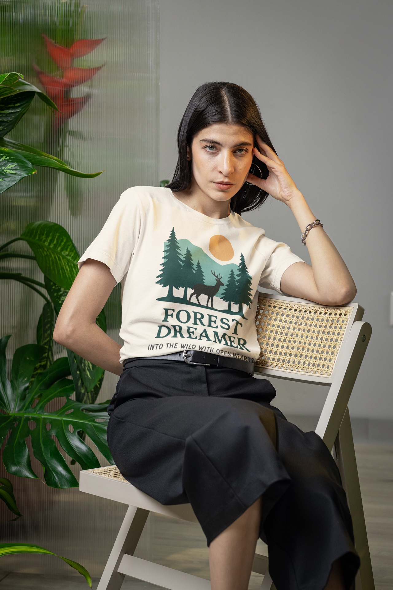 Woman wearing Forest Dreamer T-Shirt in a plant-filled room