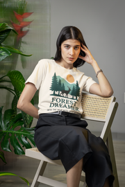 Woman wearing Forest Dreamer T-Shirt in a plant-filled room