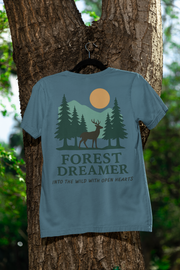 Forest Dreamer T-Shirt hanging outdoors on a tree trunk, natural setting