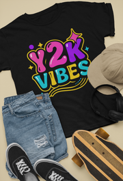 Flat lay of black Y2K Vibes T-Shirt with denim shorts and retro accessories