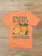 Fresh and Juicy Oranges T Shirt laid flat on wooden surface – bold retro print
