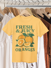 Fresh and Juicy Oranges T Shirt hanging on rack – retro citrus graphic print