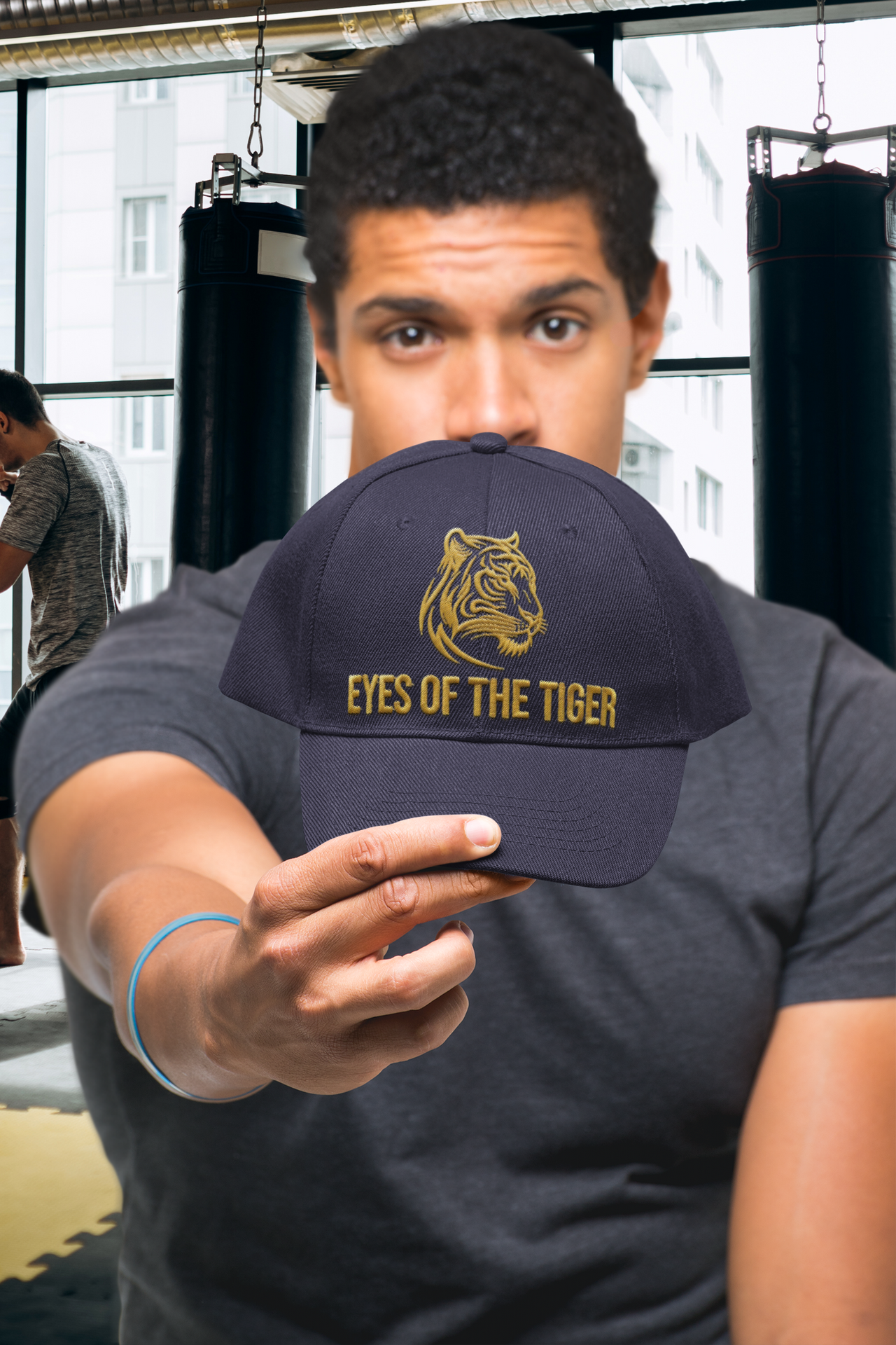 Embroidered Dad Hat Eyes of the Tiger – Black hat worn by man in casual outfit.
