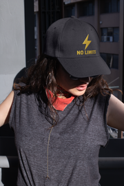 No Limits Embroidered Dad Hat – Motivational lightning bolt cap styled by woman in casual streetwear.