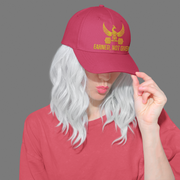 Embroidered Dad Hat Earned Not Given – Red motivational dad hat with gold embroidery worn by woman in casual fashion.