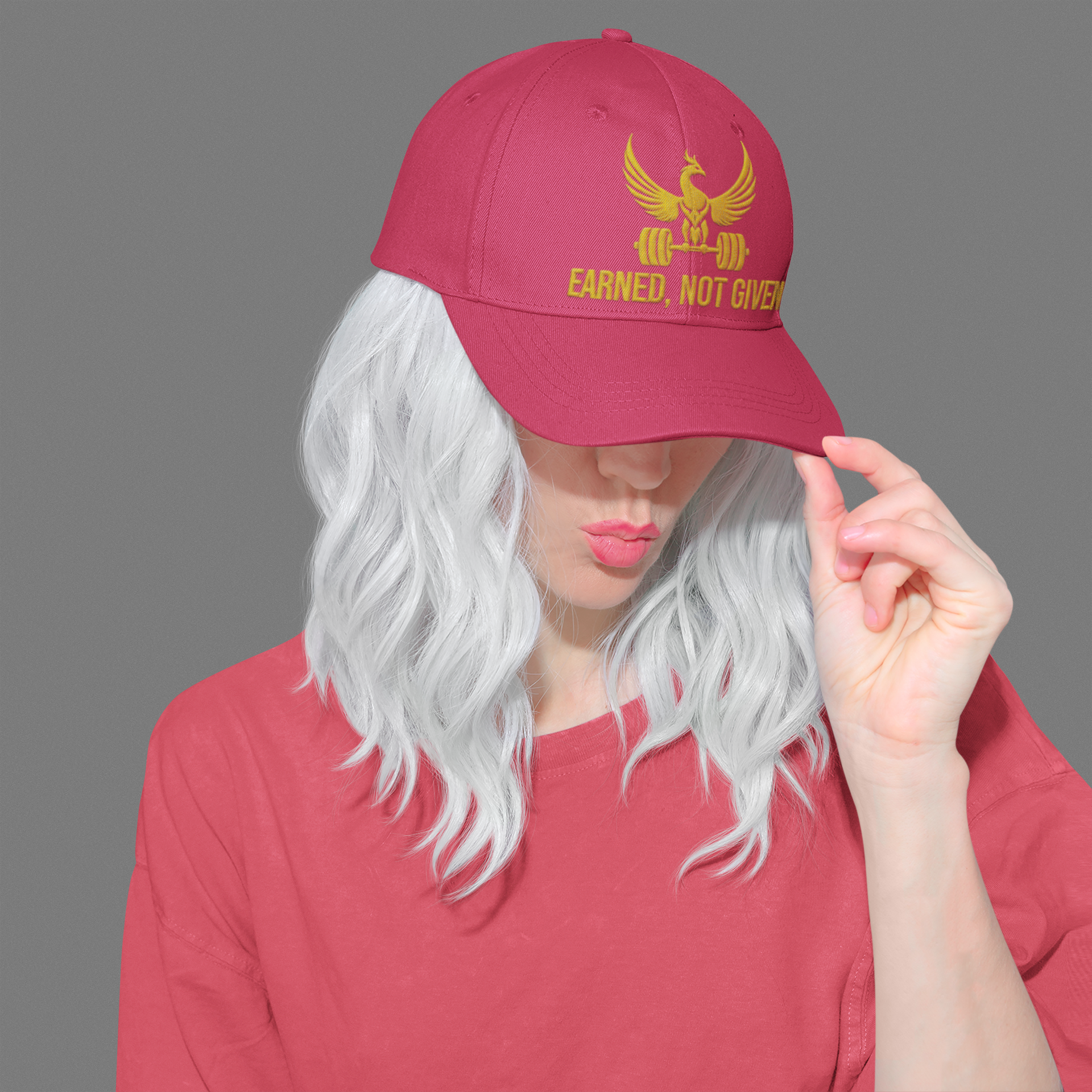 Embroidered Dad Hat Earned Not Given – Red motivational dad hat with gold embroidery worn by woman in casual fashion.