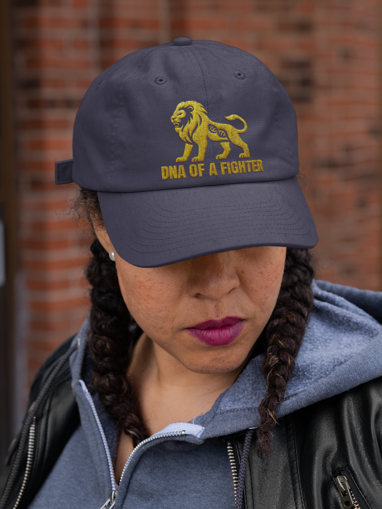 Dad Hat DNA of a Fighter Embroidered – Black motivational cap worn by woman with casual outfit.