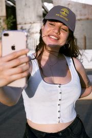 Embroidered Dad Hat Stay Grounded – Gray motivational dad hat with yellow embroidery worn by woman taking a selfie.