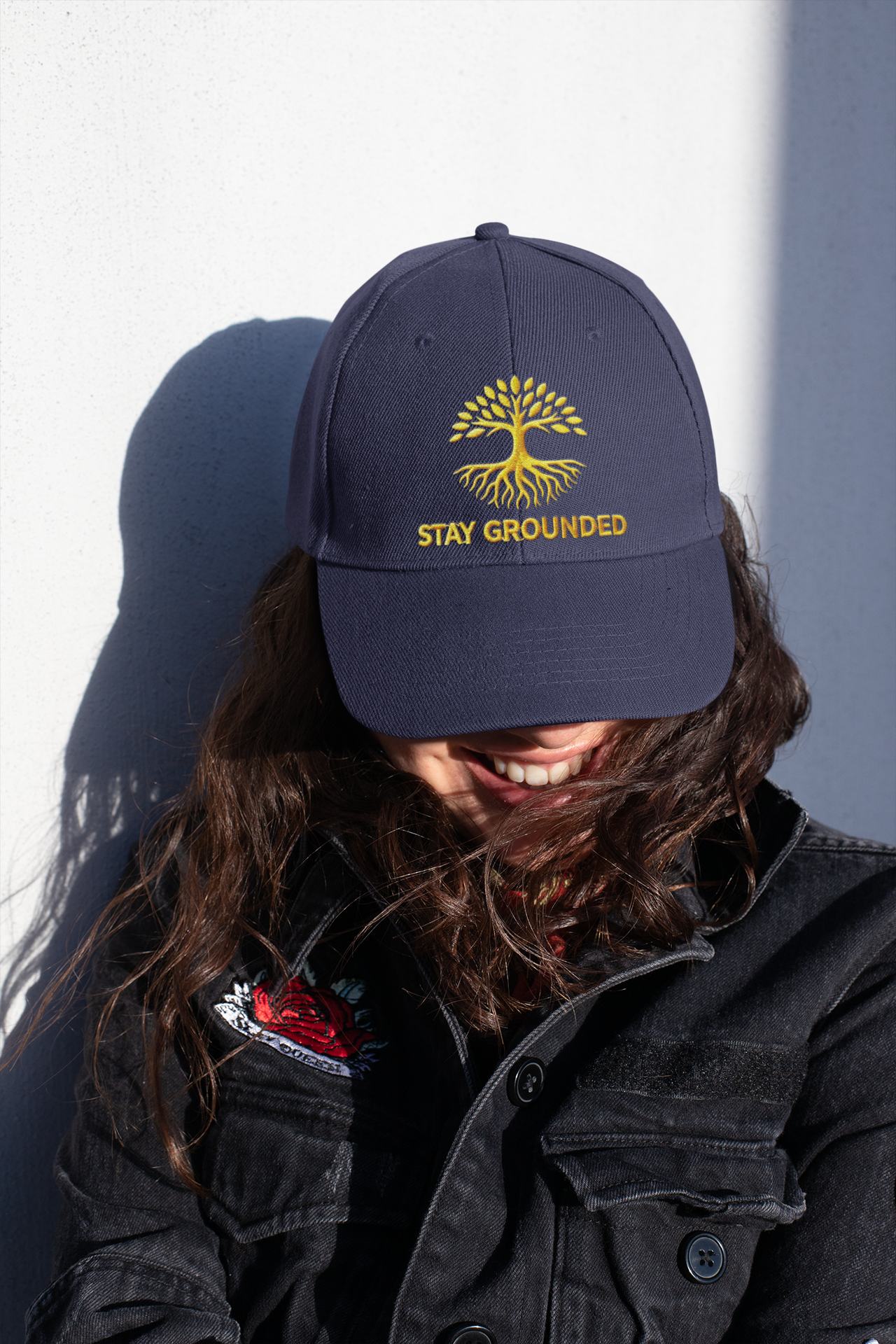 Embroidered Dad Hat Stay Grounded – Dark dad hat with motivational embroidery styled by woman in casual streetwear.