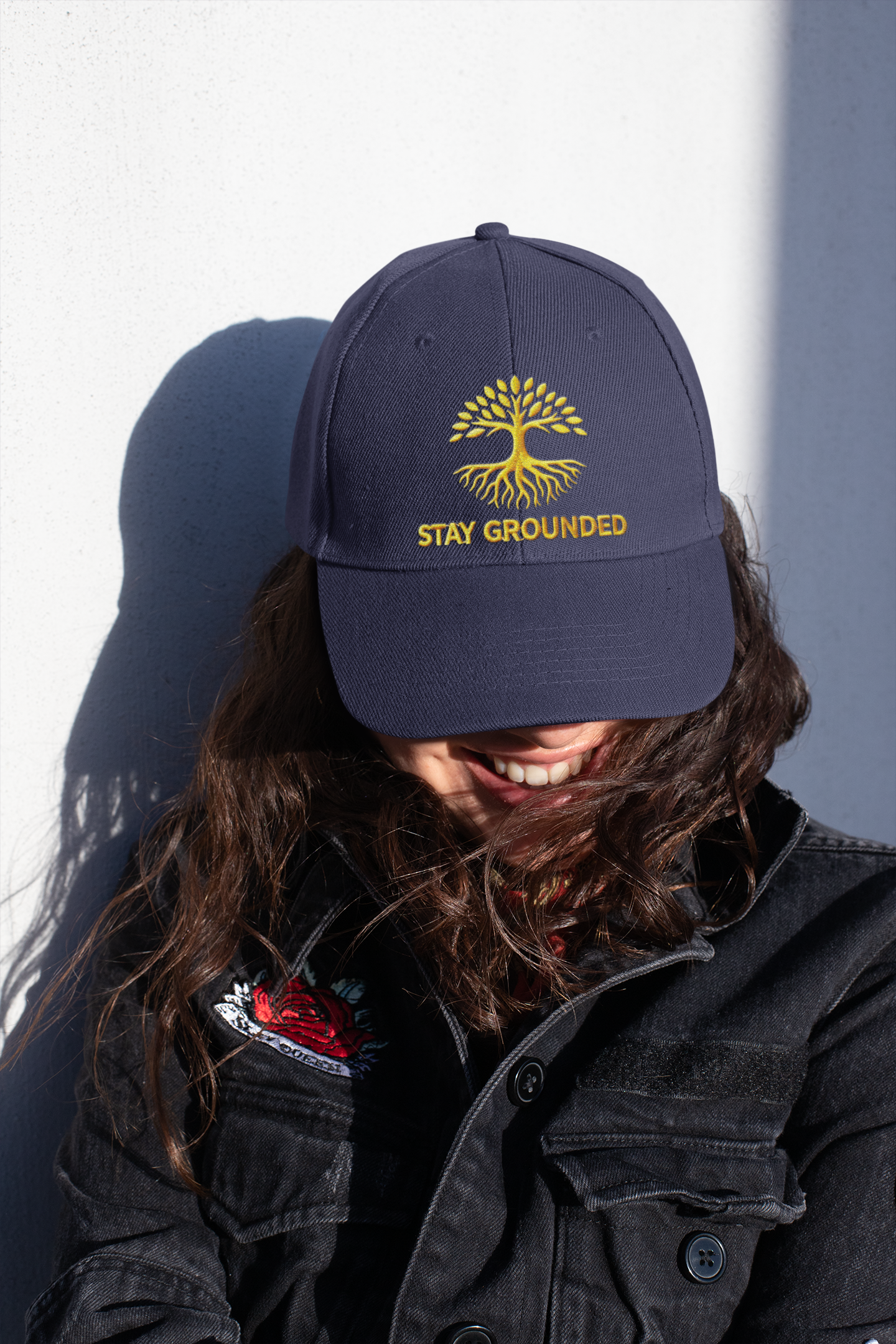 Embroidered Dad Hat Stay Grounded – Dark dad hat with motivational embroidery styled by woman in casual streetwear.