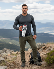 Man standing on a mountain holding a Personalized Tumbler Wolf Mode.