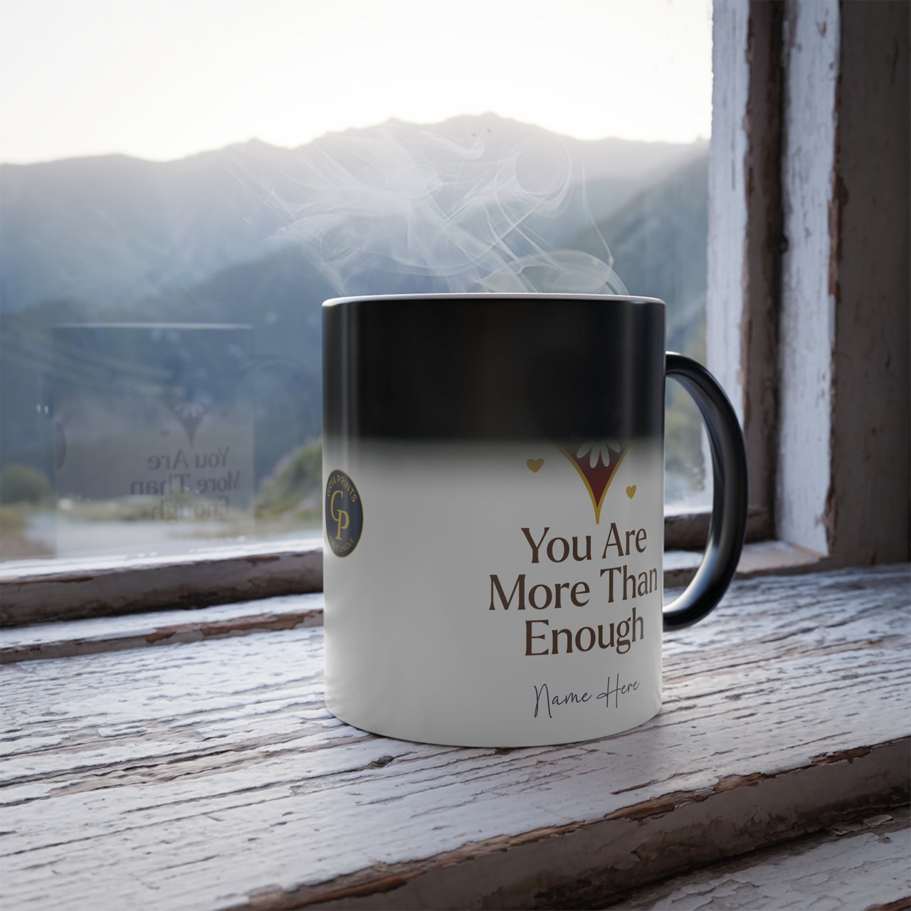 Heat Reveal Mug You Are More Than Enough with steam, showcasing motivational design by a window.
