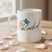 Personalized butterfly name mug with Rachel text on wooden table, floral coffee cup with petals.