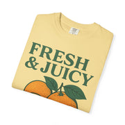 Light yellow Fresh and Juicy Oranges T Shirt folded with retro orange illustration